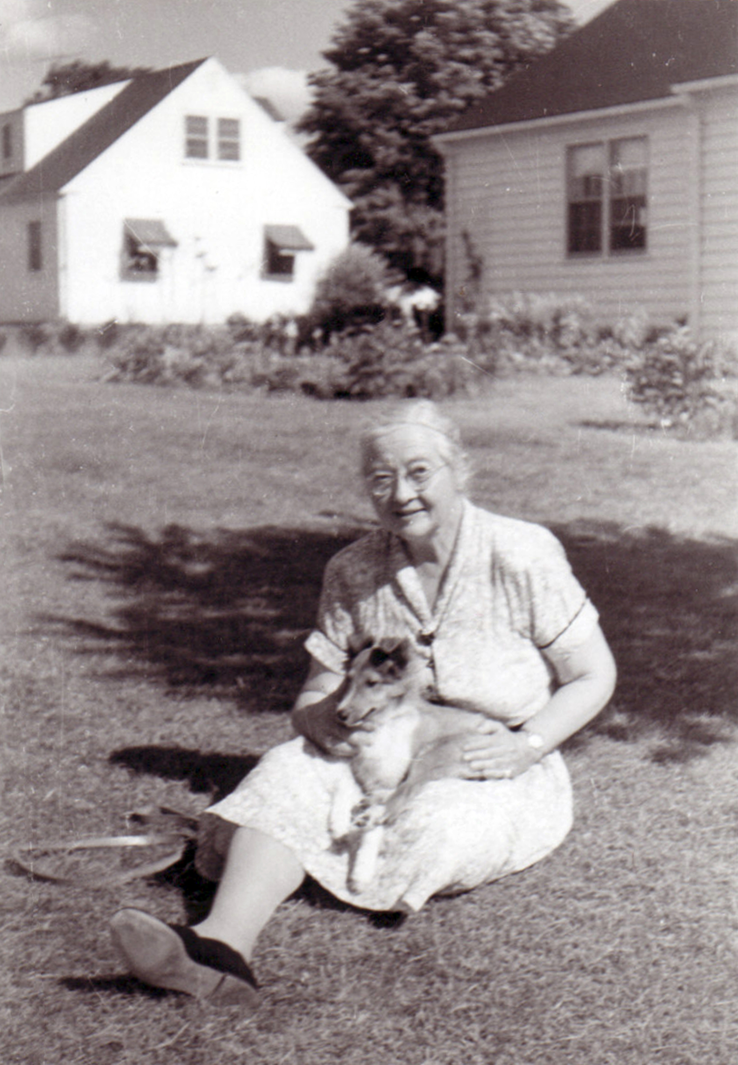 Mildred Allen sits with her dog in their yard in South Hadley Massachusetts