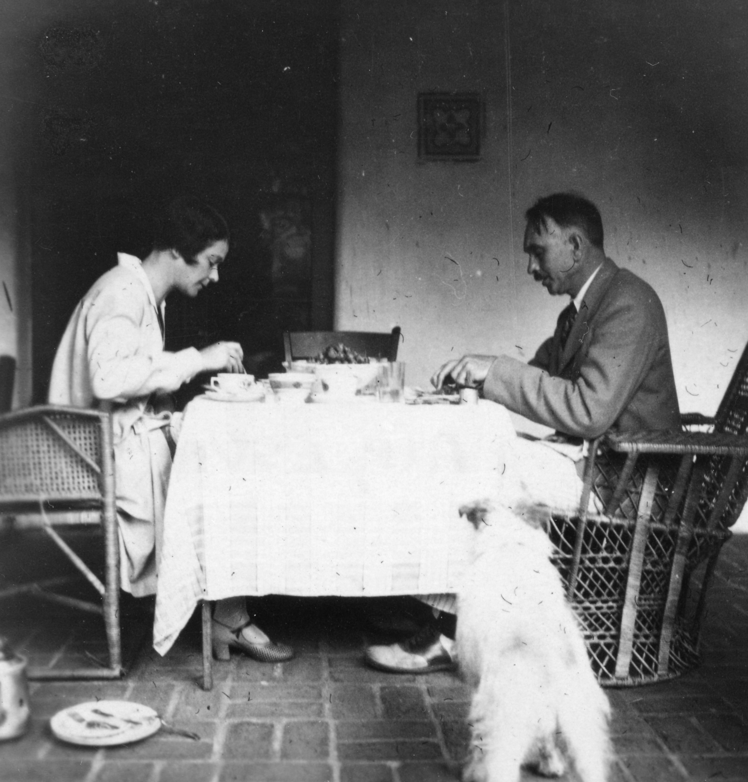 Ruth and Richard Tolman eating outside with their dog nearby
