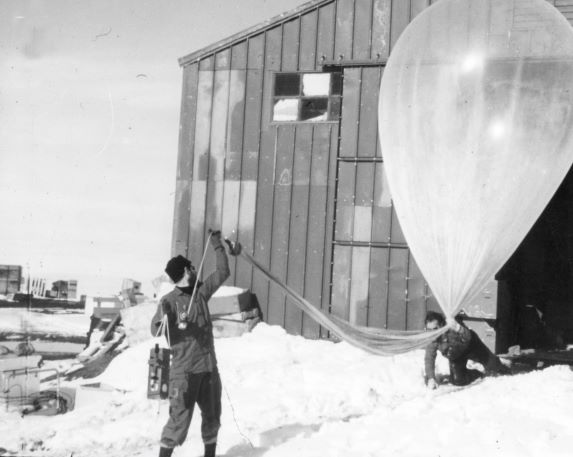 Getting a 22 foot fragile, balloon through a 12 foot doorway is overcome by Emmett J. Pybus foreground and John A. Brown