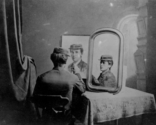 Cadet Midshipman Albert Abraham Michelson, Class of 1873, United States Naval Academy, Annapolis, seated before a mirror and apparently sketching himself.