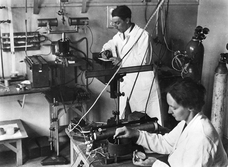 Frédéric and Irène Joliot-Curie working in a laboratory