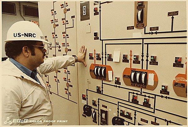 TMI-2 Control Room. NRC Inspector Looking at Meters.