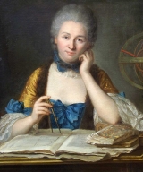 Emilie du Chatelet sits at a table leaning on one hand with the other hand holding a compass for measuring. An open book with diagrams on its pages rests in front of her. She is wearing an expensive-looking blue and gold 18th century gown and a grey powdered wig. Her skin is very light apart from some rouge on her cheeks.