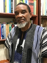 Headshot of Mahouton Norbert Hounkonnou in front of a bookshelf.