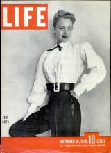 Life Magazine cover. B&W photo of woman wearing shirt, trousers, and thick leather belt with heavy metal buckle and belt end. Headline, "Big Belts". November 19, 1945. 10 cents. 