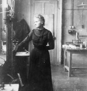 Marie Curie stands in her laboratory.