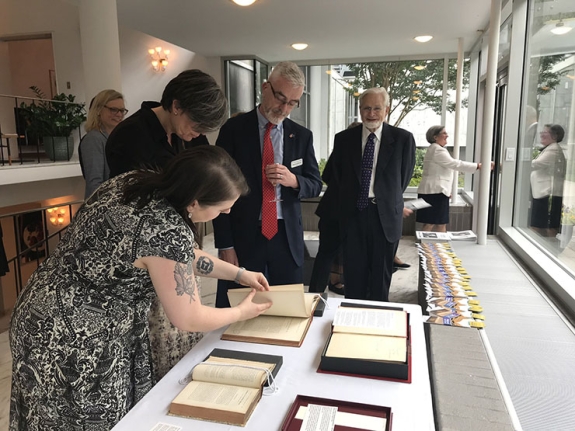 Allison Rein shows a selection of Wenner Collection books to Lone Wisborg and our CEO, Michael Moloney, at the Danish Embassy.