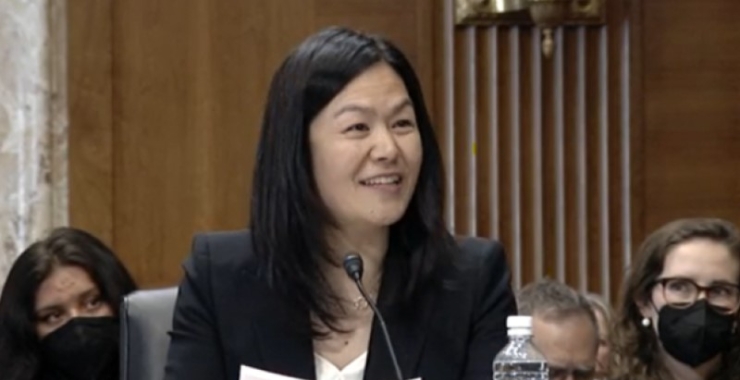 Evelyn Wang, seated and smiling as she speaks at her nomination hearing