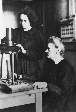 Marie Curie (right) with daughter and chemist Irène Joliot-Curie working in the lab.