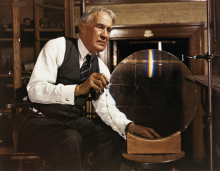 R. W. Wood in shirt sleeves and a waistcoat and tie with his mosaic replica diffraction grating, circa 1938.
