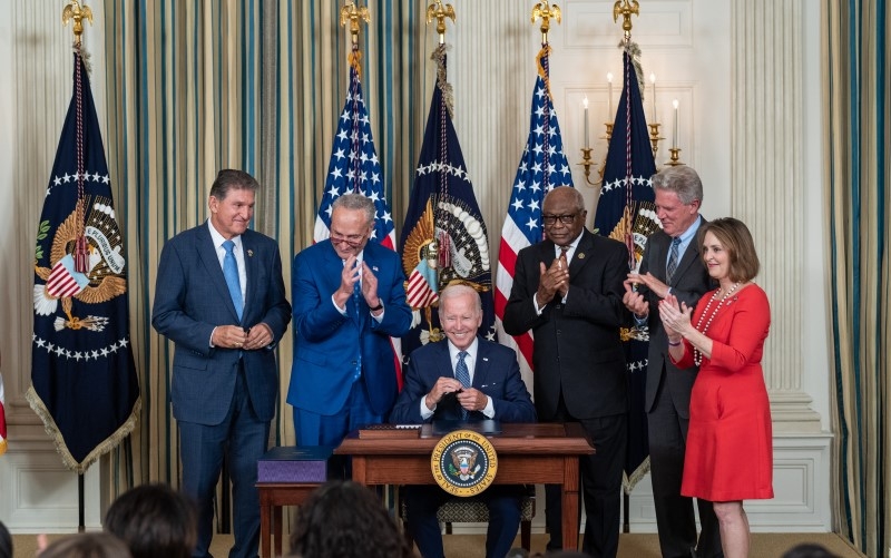 President Biden signs the Inflation Reduction Act, surrounded by congressional leaders