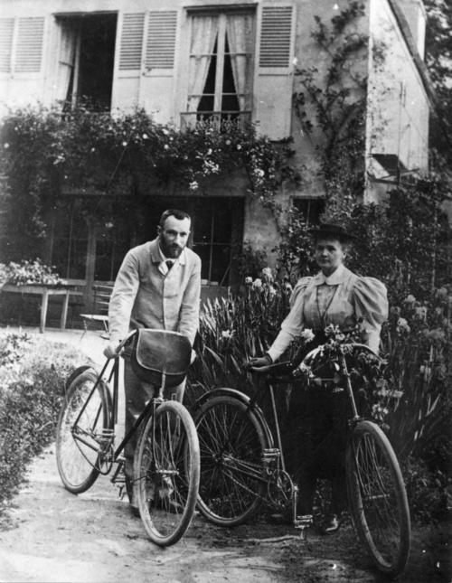 Pierre Curie, Marie Curie stand with their bicycles