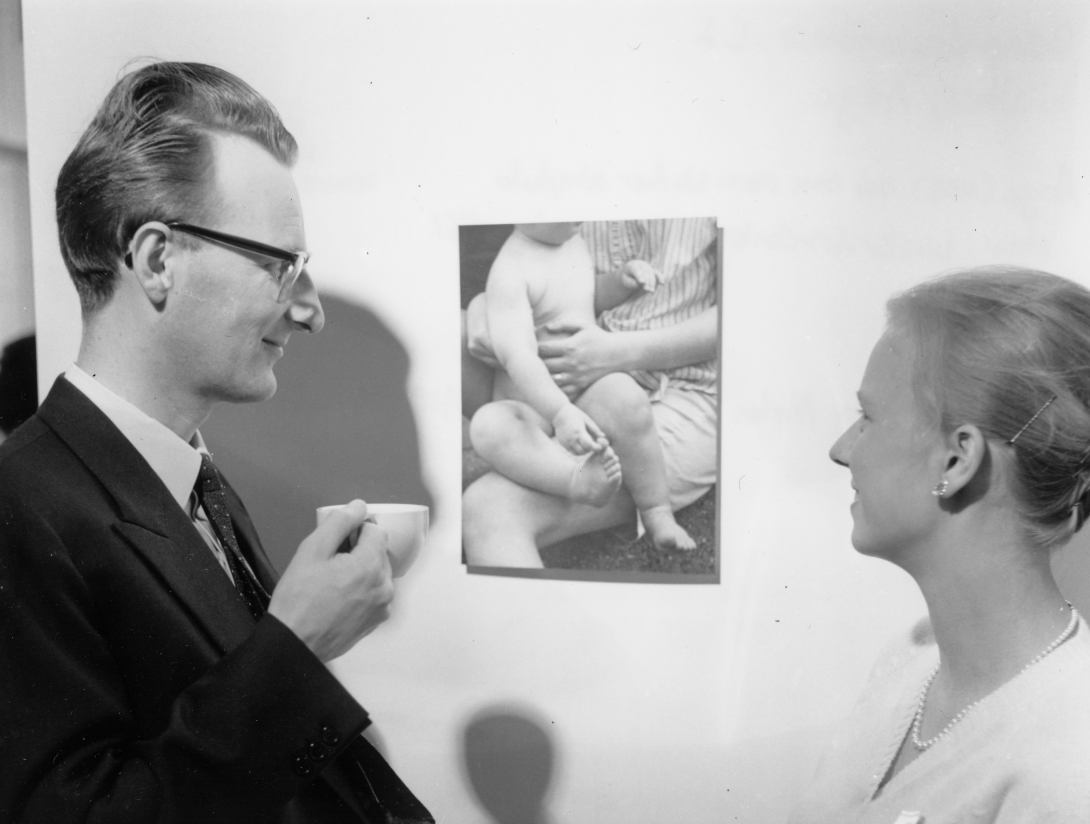 Aage Winther, left, looks at a photograph next to his wife, Anna Maria, against a white background