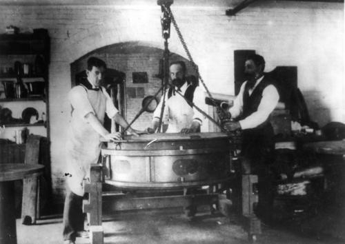 Three men inside of the Alvan Clark and Sons Telescope Factory.