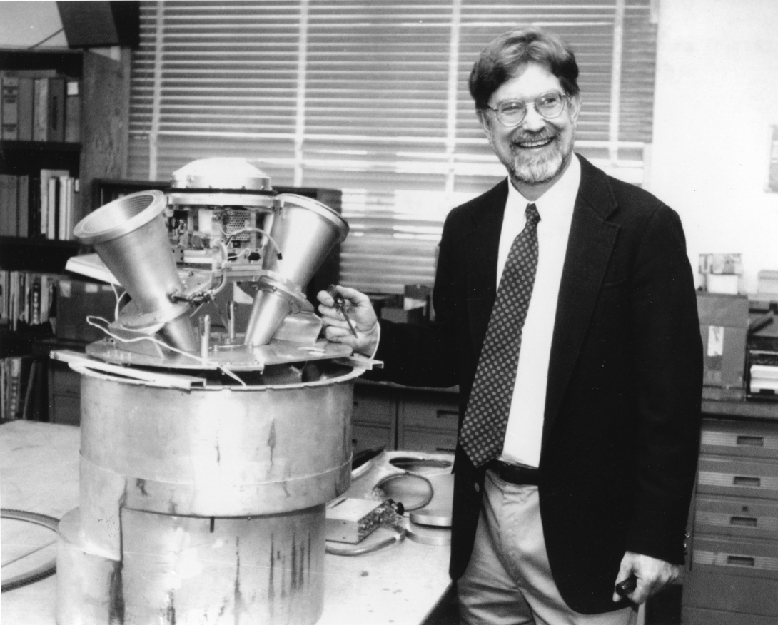 George F. Smoot and the U2 receiver. The receiver is about as large as he is, and consists of a metal cylinder with two metal funnels on top.