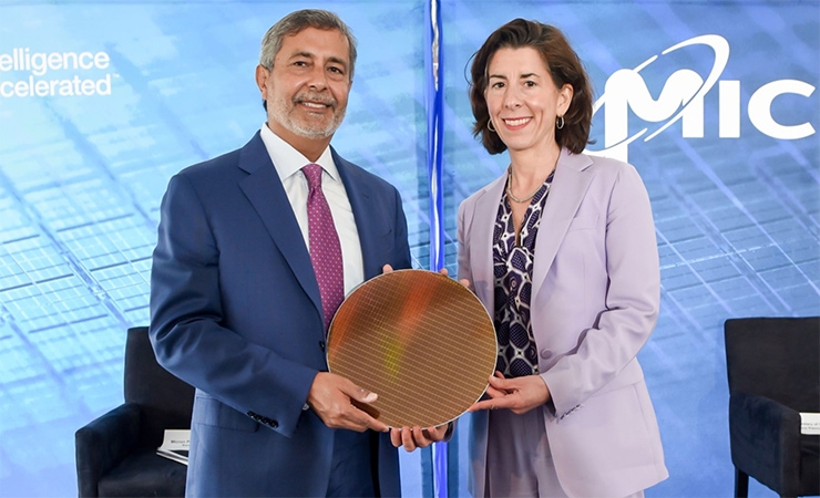 Commerce Secretary Gina Raimondo holds a silicon chip wafer with Micron Technology CEO Sanjay Mehrotra at the company’s fabrication facility in Virginia.