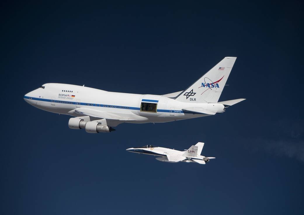 The SOFIA 747SP on a high-altitude test flight in 2010, accompanied by a NASA F/A 18 mission support aircraft.