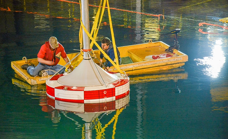 Researchers from Sandia National Laboratories test a wave energy converter at the U.S. Navy’s indoor test facility in Carderock, Maryland.