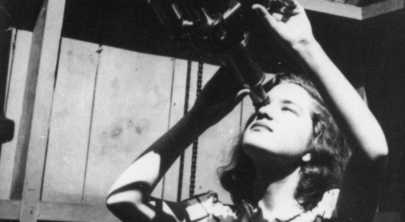 Vera Rubin looking through a telescope at Vassar College.