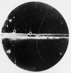 First image of a positron track by C. D. Anderson. Published in “Positrons from Gamma Rays” by Carl Anderson and Seth Neddermeyer, Physical Review, v. 43, 1933.