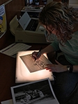Amanda tracing a Henry Barton photo using the lightbox.