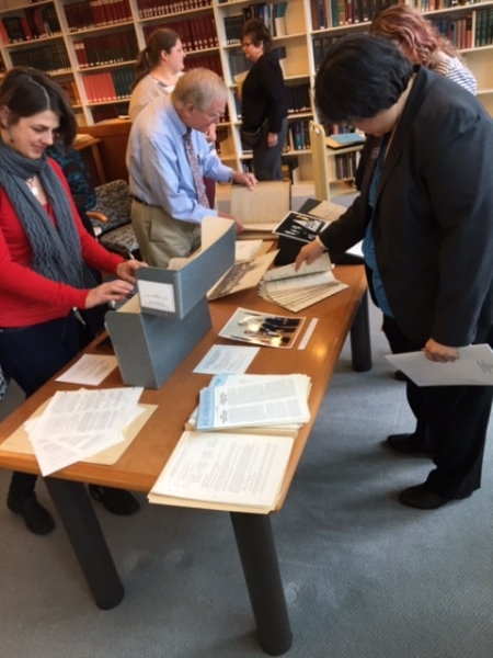 Member Society representatives and staff looking at their society’s historical documents.