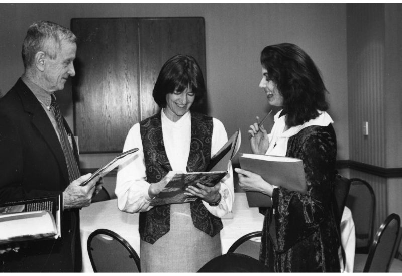 Robert Park, Sally Ride, and Jennifer Oullette converse with books in hand. 