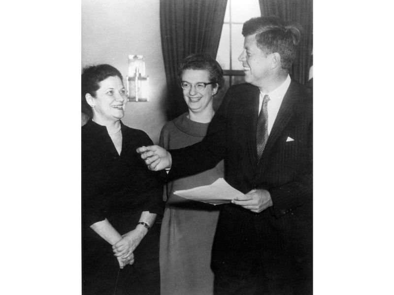 Nancy Grace Roman poses with President John F. Kennedy and Evelyn Harrison.