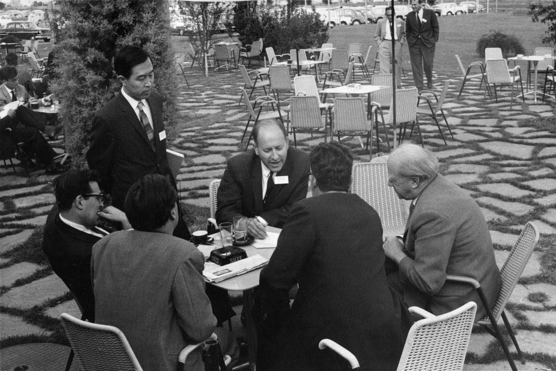 Candid group photo of Yoichiro Nambu, Julian Schwinger, Robert E. Marshak, Werner Heisenberg, and others